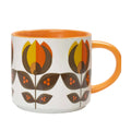 A white ceramic mug with a retro mid-century modern floral pattern in orange, yellow, and brown, featuring a solid orange handle and interior.