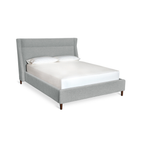 Modern grey upholstered bed with tall headboard and wooden legs, styled with white bedding and pillows