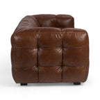 Brown tufted leather sofa with a modern, plush design and deep cushioning viewed from the side.