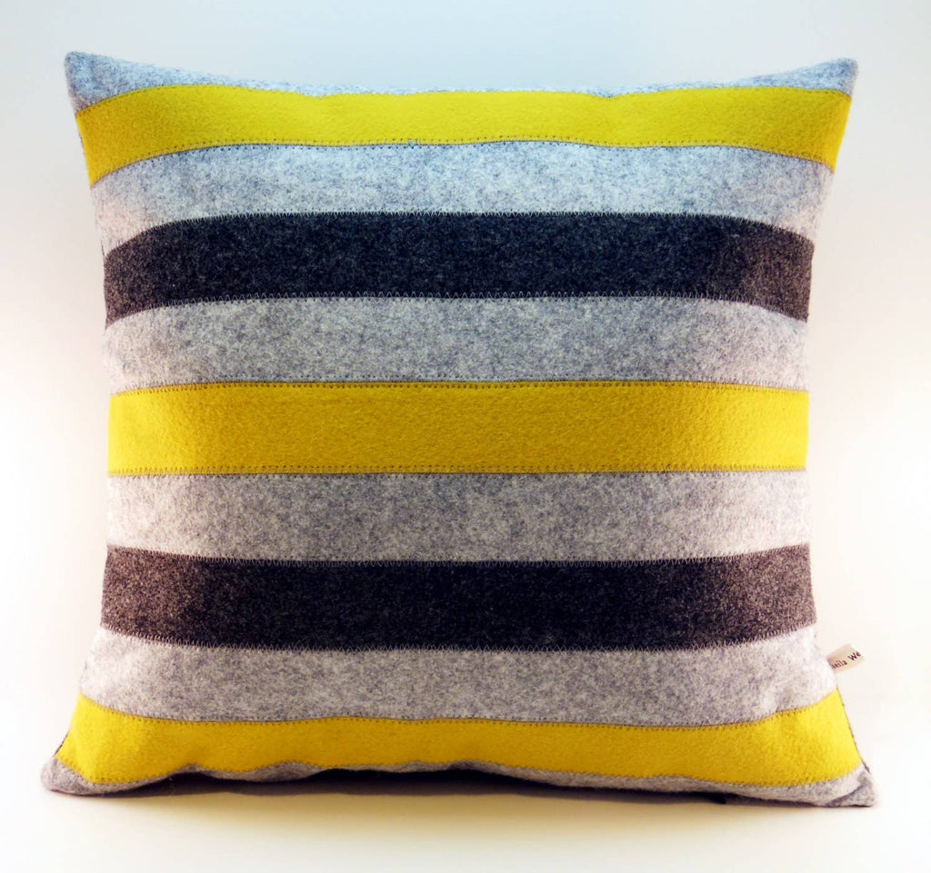 Square wool felt pillow featuring horizontal yellow, gray, black, and white stripes for home decor.