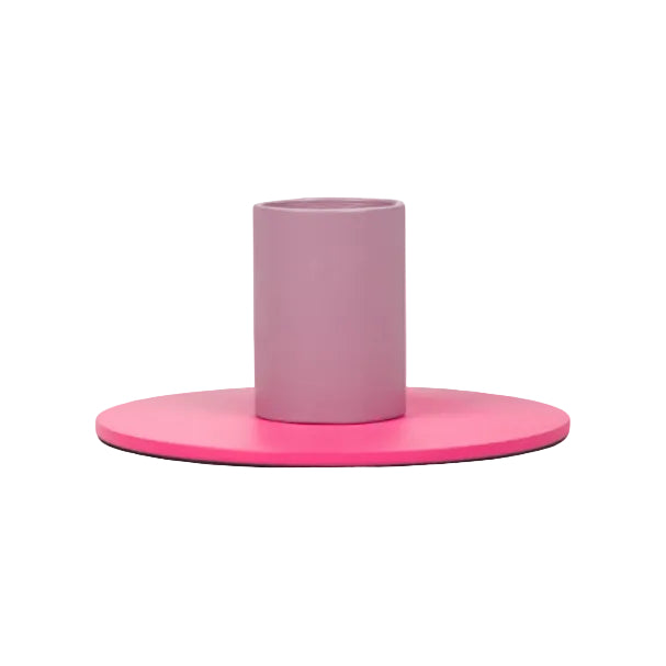 Minimalist two-tone metal candle holder with a pink base and cylindrical holder in muted rosy tone