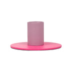 Minimalist two-tone metal candle holder with a pink base and cylindrical holder in muted rosy tone