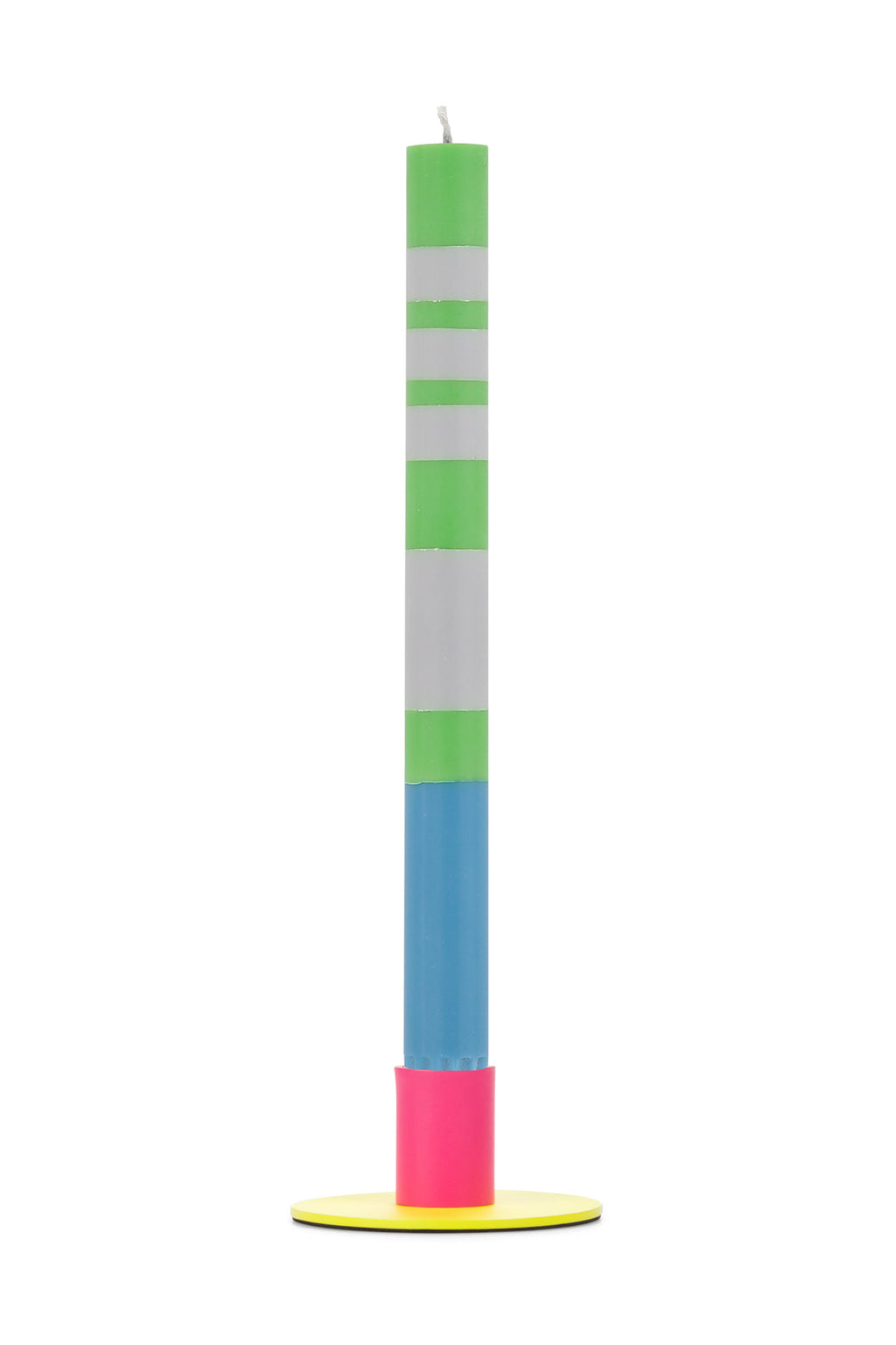 Tall colorful candle with green, white, blue, and pink sections on a yellow metal holder against a white background