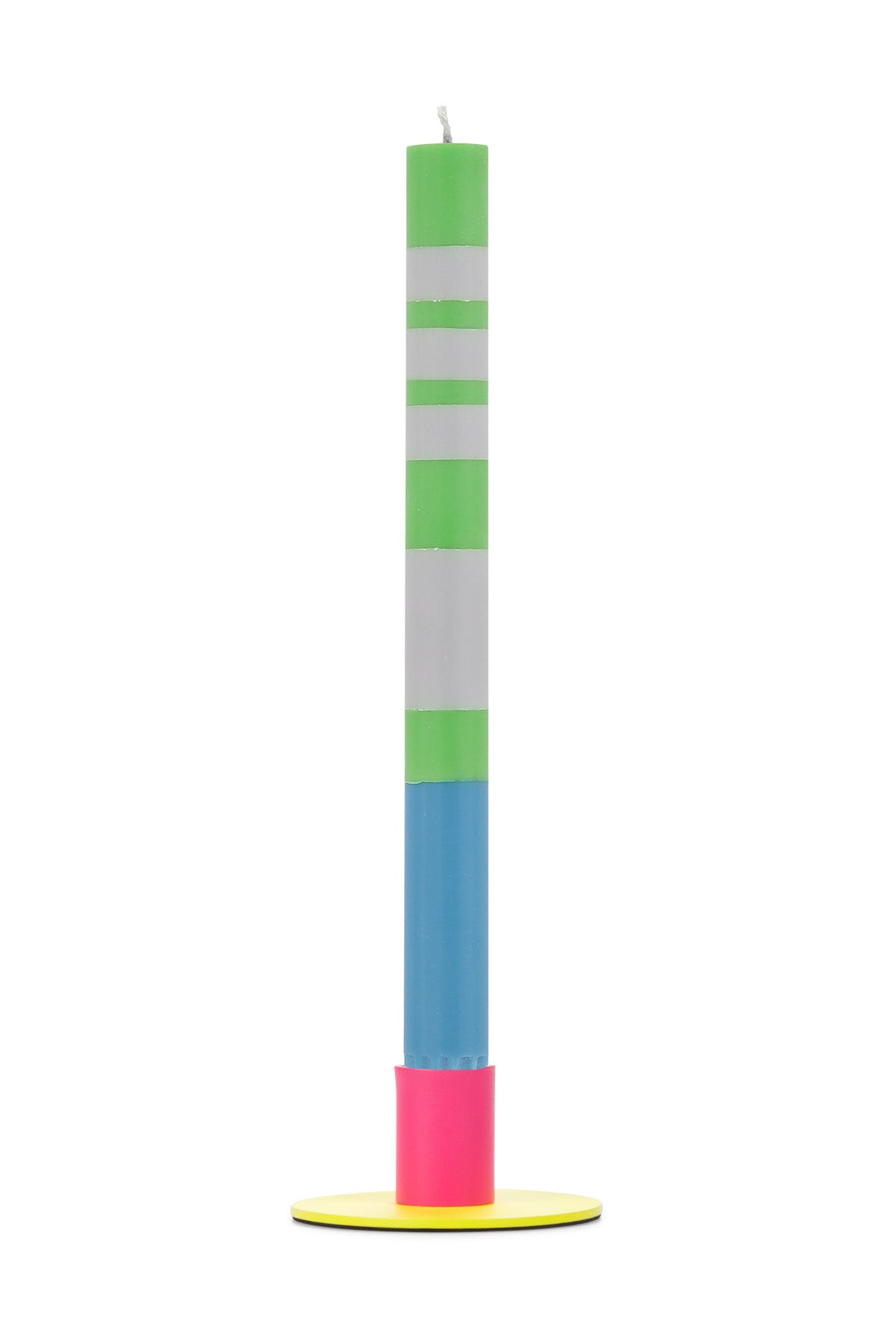 Tall colorful candle with green, white, blue, and pink sections on a yellow metal holder against a white background