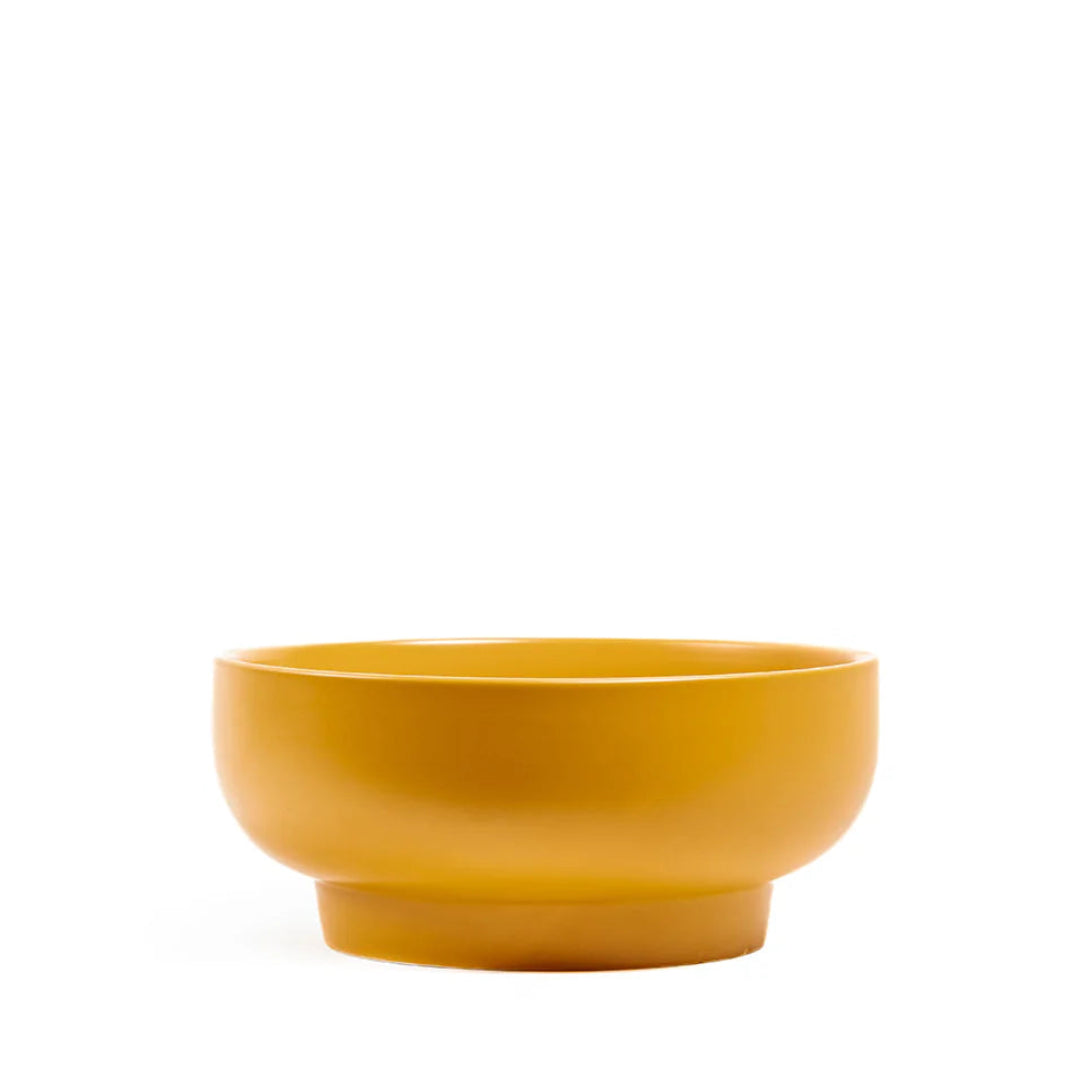 mustard ceramic bowl on a white background