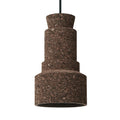 Small pendant light with textured cork material and modern geometric shape hanging from a cord