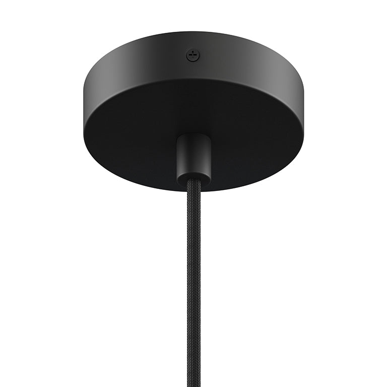 Close-up of a matte black ceiling mount and cord for a small modern pendant light fixture.