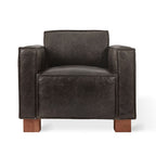 Modern dark leather armchair with wide armrests and wooden block legs in contemporary style