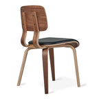 Modern dining chair with curved wooden frame and black cushioned seat, midcentury design style.