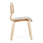 Side view of a modern dining chair with curved wooden frame and white cushioned seat.