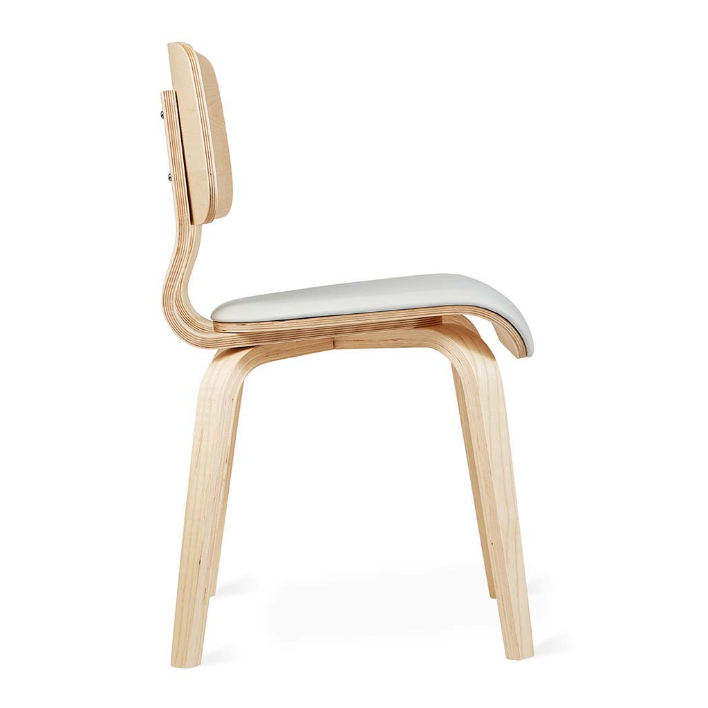 Side view of a modern dining chair with curved wooden frame and white cushioned seat.