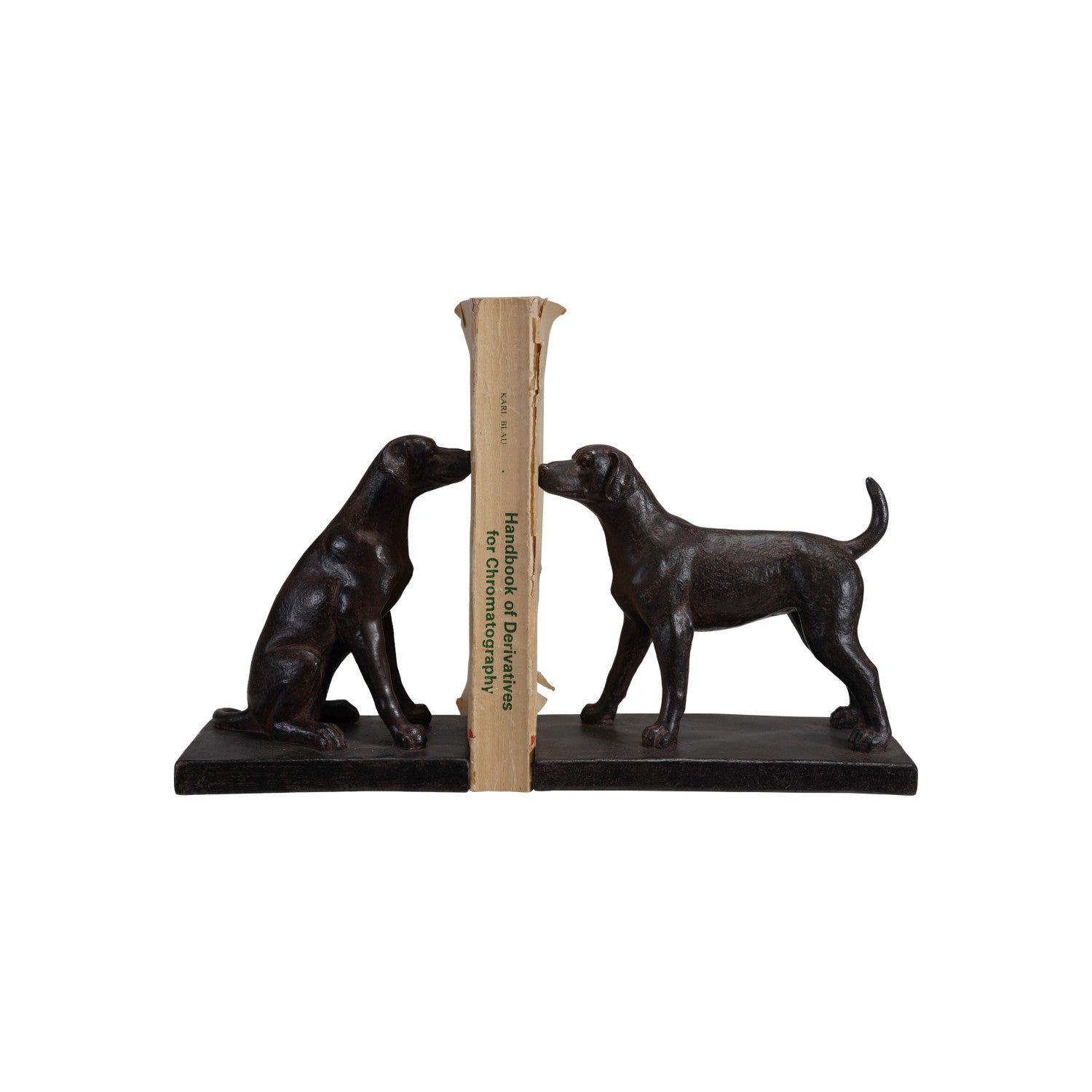 Black bookends shaped like dogs holding book on a white background