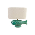 A table lamp featuring a glossy green fish-shaped ceramic base and a cylindrical beige fabric drum shade, shown against a plain white background.