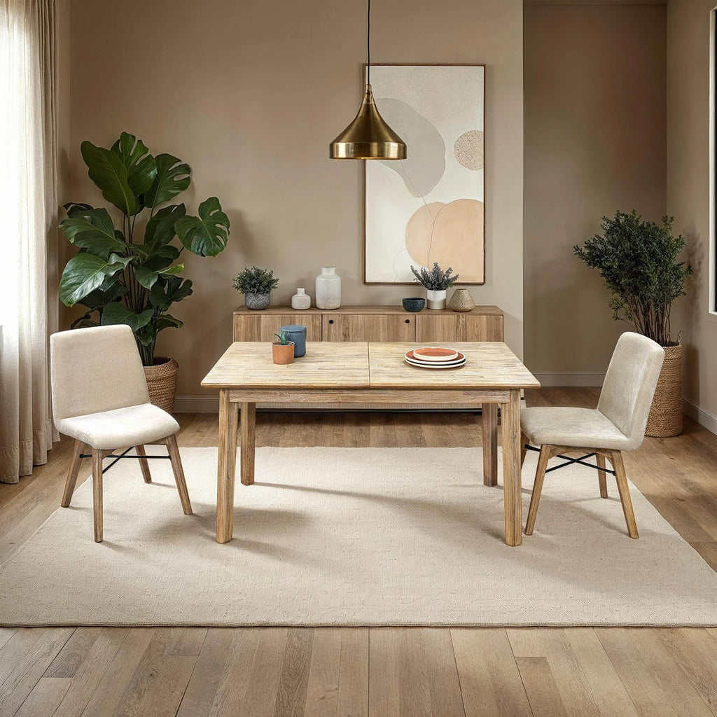 Light wood extension dining table set with two beige upholstered chairs on area rug in modern dining room