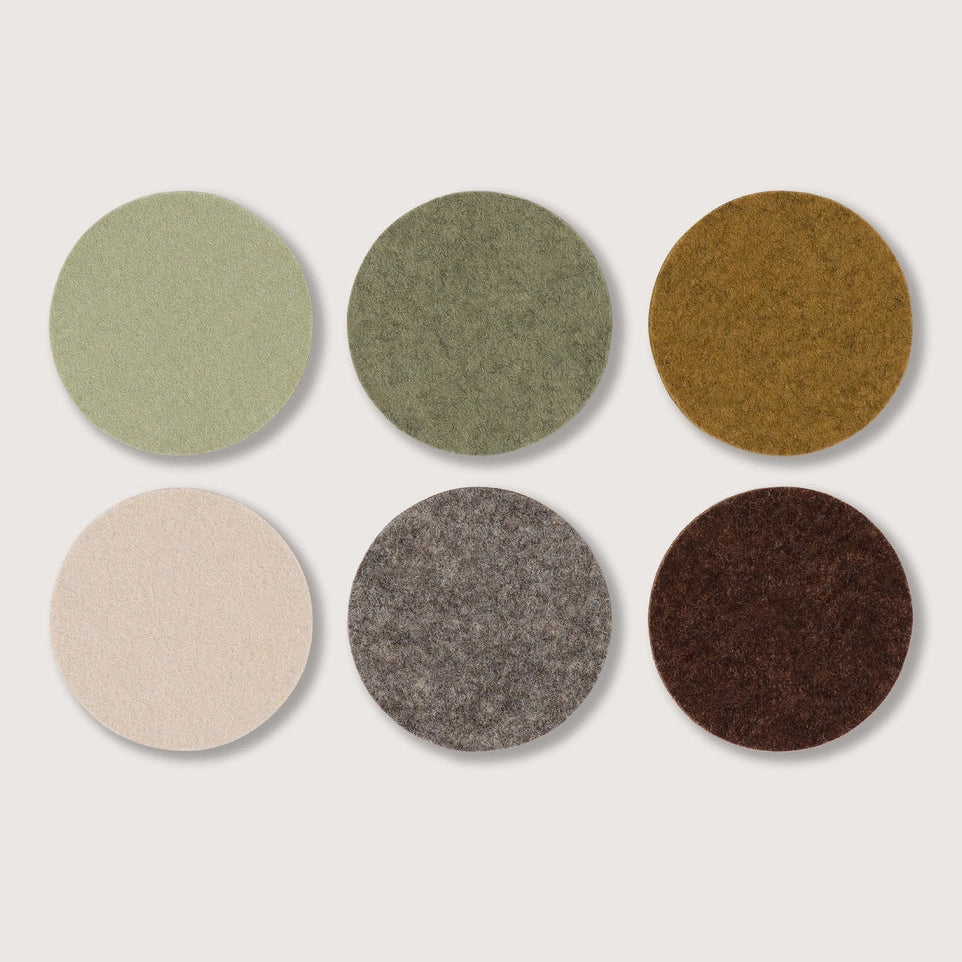 Six circular fabric swatches arranged in a 2x3 grid on a light beige background. The swatches include sage green, olive green, mustard yellow, cream, heather gray, and dark brown.