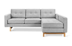 Light gray fabric bi-sectional sofa with tufted cushions and wooden legs in a modern minimalist style
