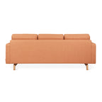 Back view of a modern orange fabric sectional sofa with wooden legs and adjustable headrests