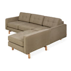 Modern bi-sectional sofa in natural beige fabric with tufted cushions and wooden legs, ideal for living room seating.