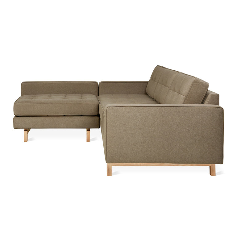 Modern bi-sectional sofa with tufted cushions and wooden legs in a neutral natural mocha fabric color