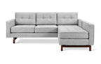 Gray fabric midcentury modern bi-sectional sofa with tufted cushions and walnut-finished wooden legs.