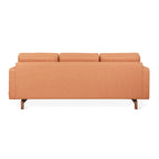 Back view of a modern orange fabric sectional sofa with wooden legs on a white background