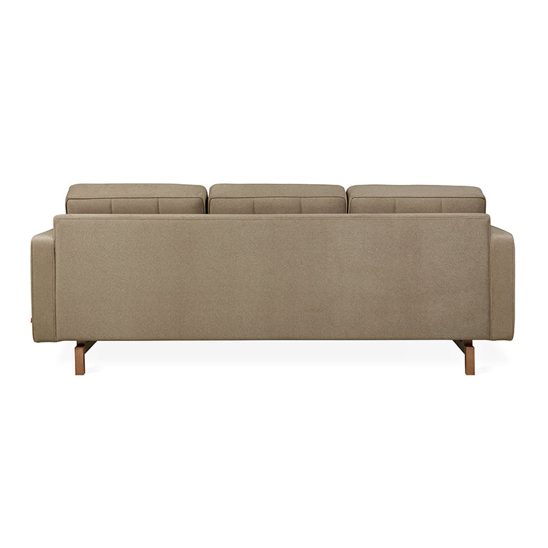 Back view of a modern mocha fabric sectional sofa with clean lines and walnut-finished wooden legs.