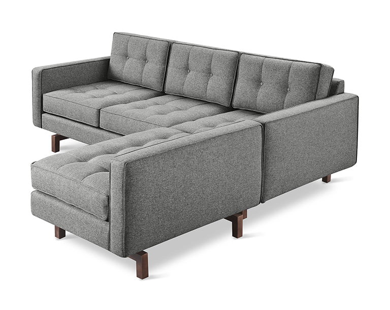 Modern gray fabric bi-sectional sofa with tufted cushions and wooden legs designed for comfortable seating.