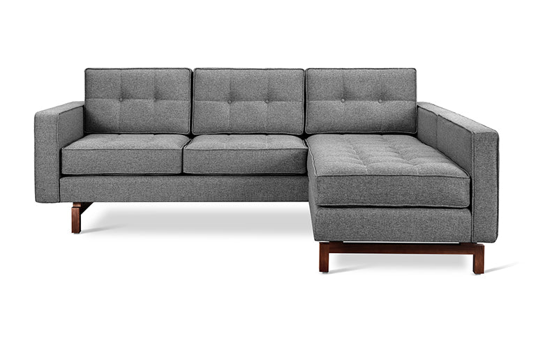 Modern gray fabric sectional sofa with tufted cushions and walnut-finished wooden legs in a bi-sectional design