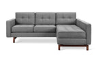 Modern gray fabric sectional sofa with tufted cushions and walnut-finished wooden legs in a bi-sectional design
