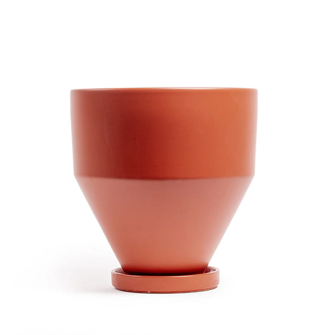 Terracotta-colored planter and drip tray on a white background