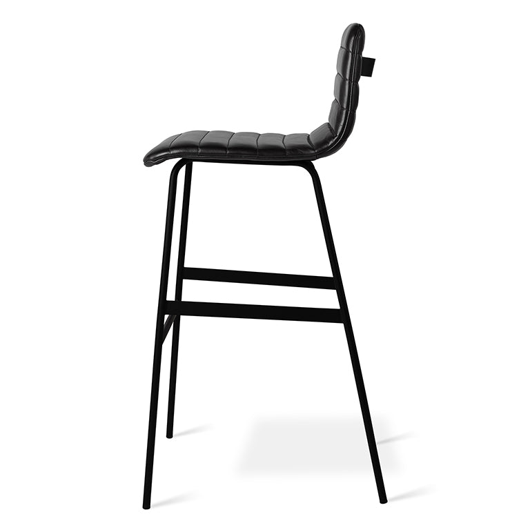 Black upholstered bar stool with padded seat and backrest supported by a slim black metal frame and footrest
