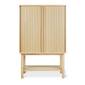 Wooden tall cabinet with vertical slatted doors and open lower shelf in a light oak finish