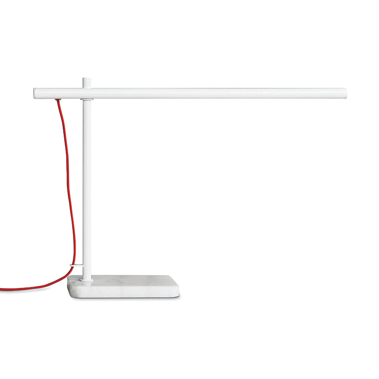 Modern white task lamp with a slim horizontal arm and red power cord on a rectangular base