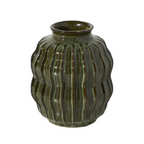 A ribbed ceramic vase with a glossy dark green glaze, set against a plain white background.