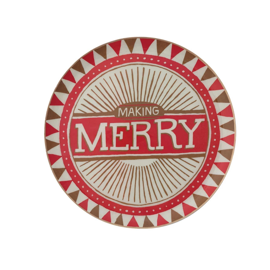 Round decorative metal tray with red, white, and gold geometric patterns and festive "Making Merry" text in the center