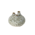 A small ceramic bud vase with three protruding necks, covered in a speckled cream and olive-green glaze with subtle gold accents on the rims, set against a plain white background.