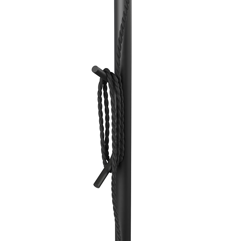Close-up of a black floor lamp pole featuring a twisted rope detail wrapped around a peg.