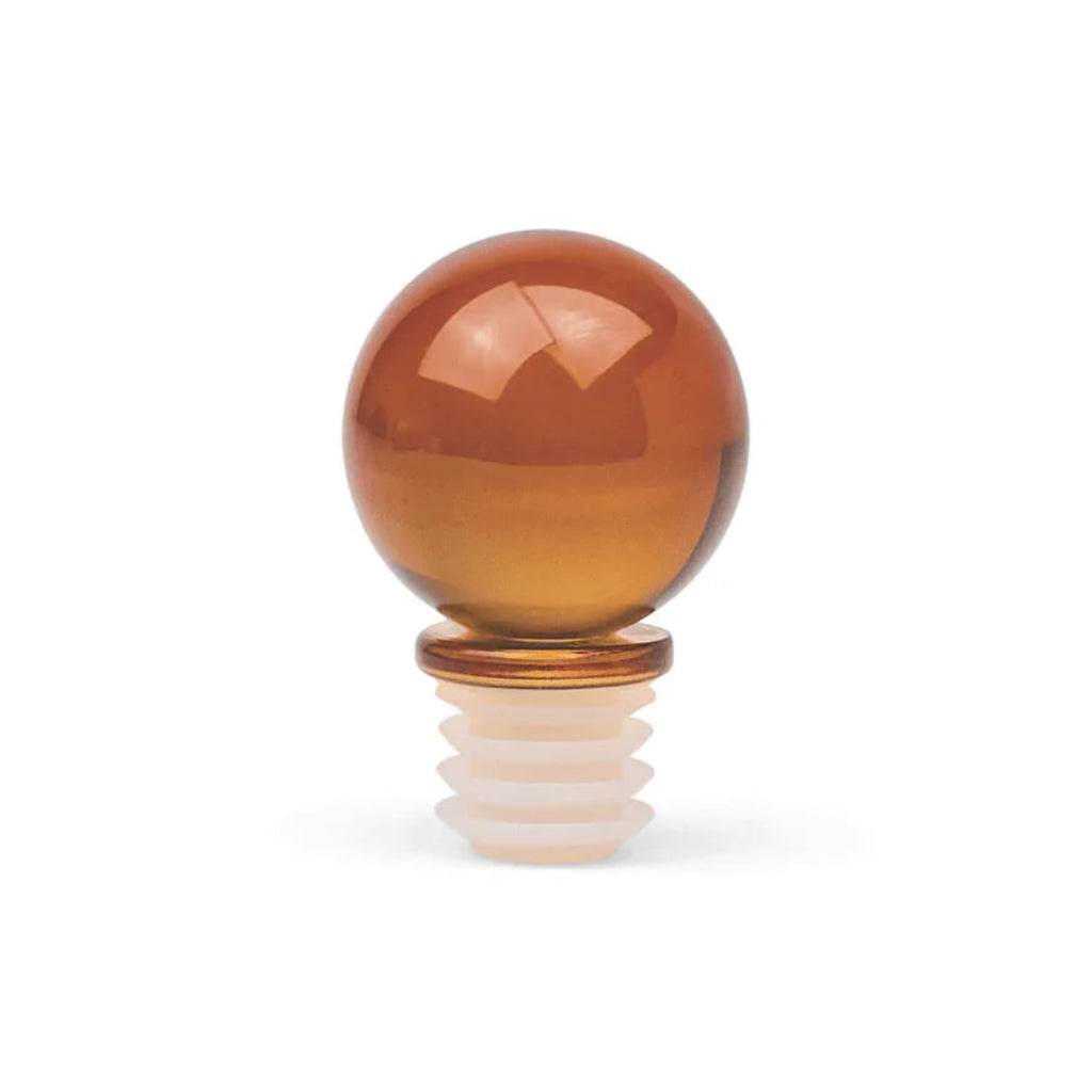 An amber glass bottle stopper with a rounded, polished sphere on a ridged white base, shown on a clean white background.