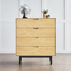 Minimalist four-drawer wooden dresser with light oak finish, black metal legs, vintage fan, and small potted plants on top