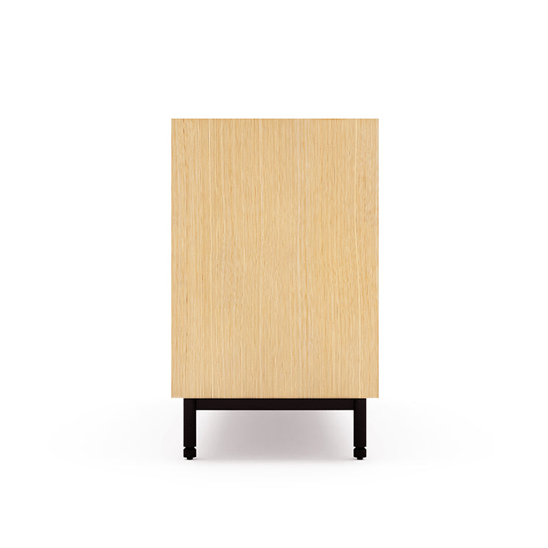 Side view of a wooden dresser with a light oak finish and black metal legs on a white background