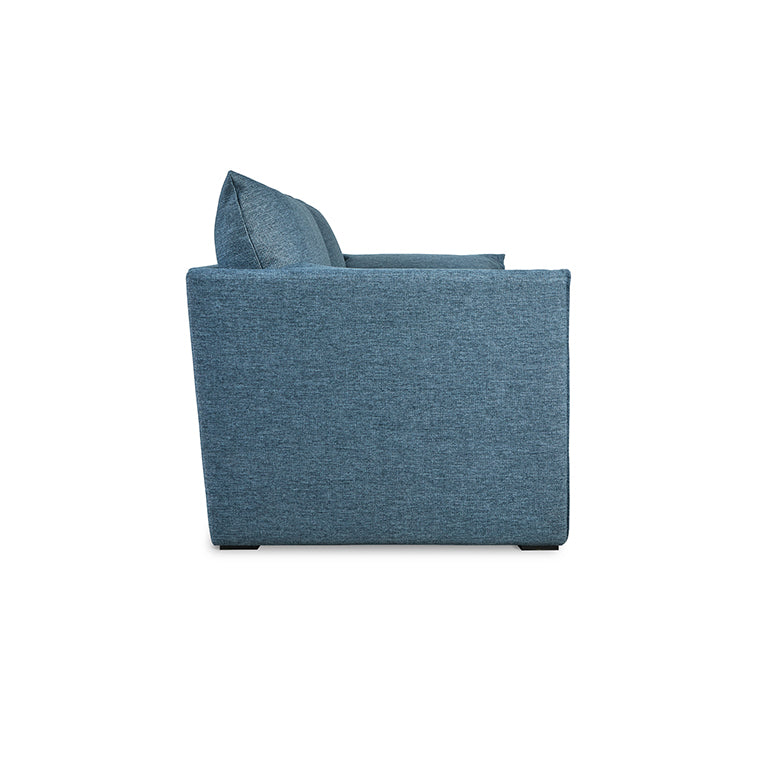 Side view of a modern blue fabric sofa with a cushion and clean, squared armrest design.