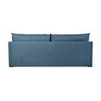 Back view of a modern blue fabric sofabed with two loose back cushions and clean lines