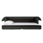 Modern sofa bed in dark fabric fully extended with white pillow on mattress surface