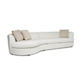 Curved white upholstered sectional sofa with beige pillows and modern design on low black legs.