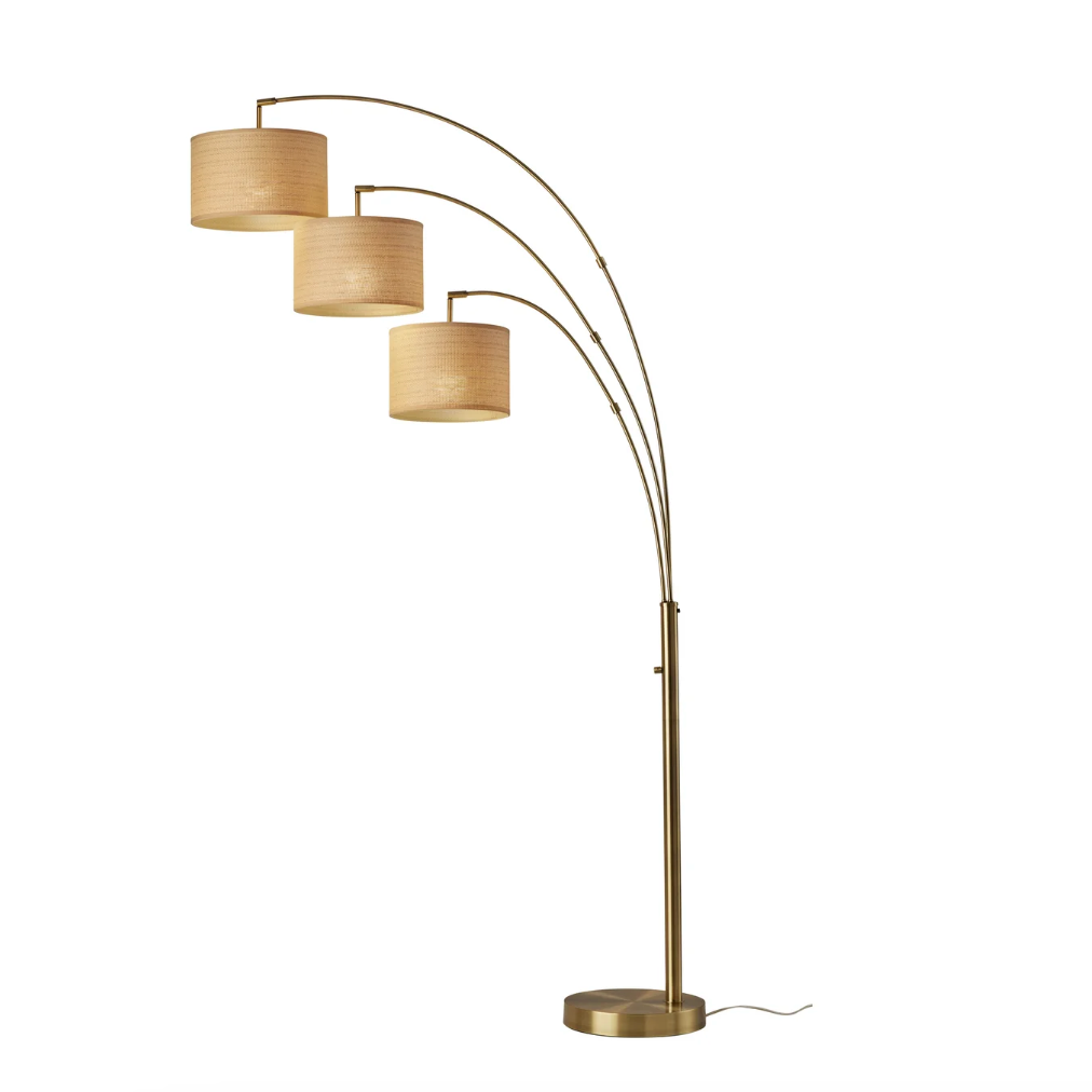 Modern arc floor lamp with three fabric drum shades and brass finish for stylish home decor lighting