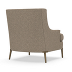 Back view of a modern upholstered chair with slim wooden legs and a textured beige fabric finish