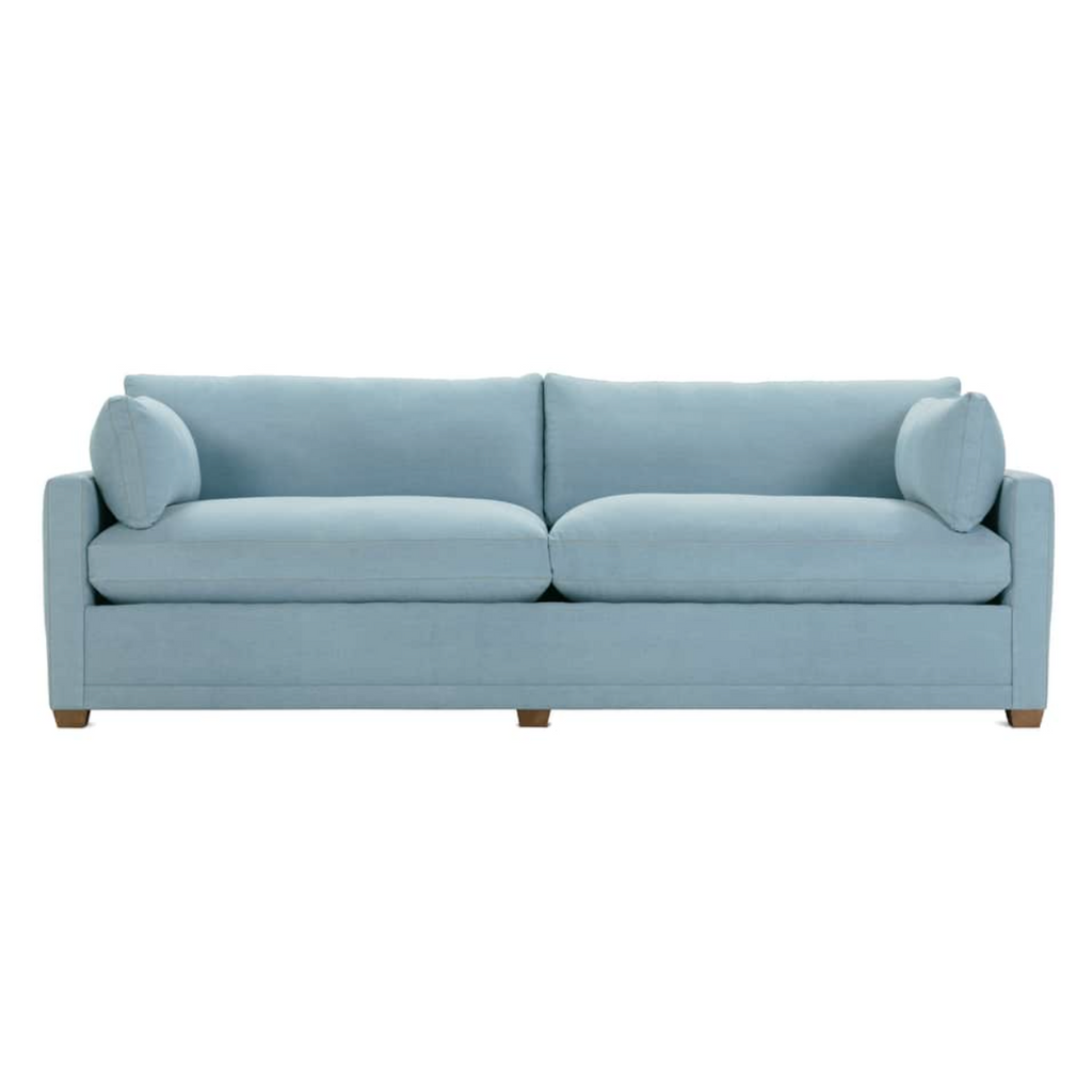 Light blue denim sofa with clean lines, plush cushions, and wooden block legs, ideal for modern living spaces
