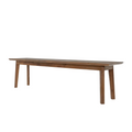 A long rectangular wooden bench with four legs, shown from a three-quarters angle on a plain white background.