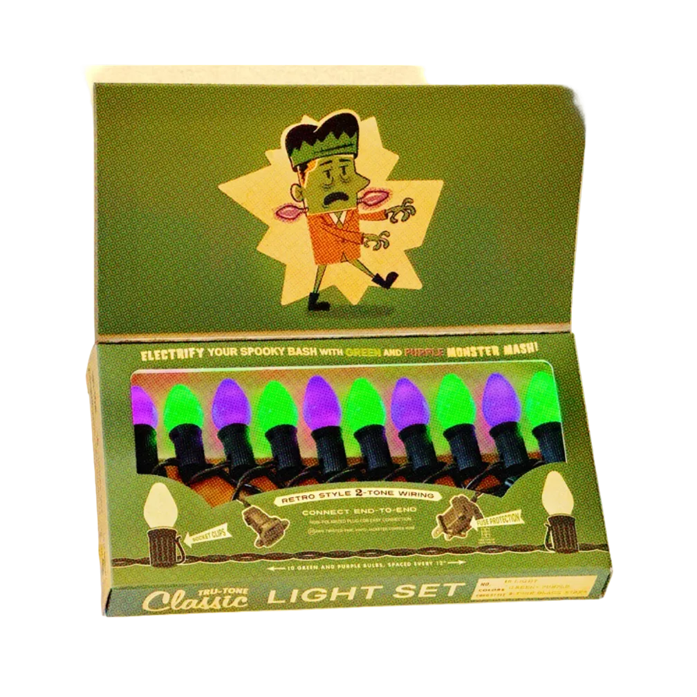 A vintage-style Halloween light set in a green box with illustrated Frankenstein graphics and visible green and purple bulb colors.