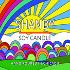 Colorful illustrated label with a rainbow, sunburst, and text promoting a handmade soy candle from Chicago